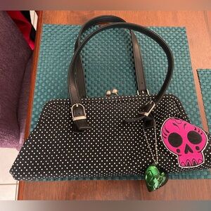 Sour puss black and white polkadotted purse with hot pink skull. EUC.